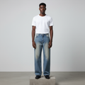 Nigerian male model wearing blue vintage wash wide-leg jeans