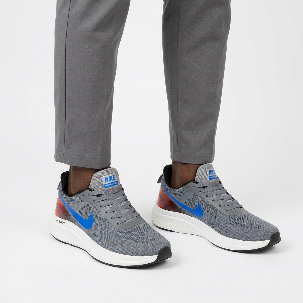 Both feet wearing grey mesh blue-accent sneakers on a plain white background