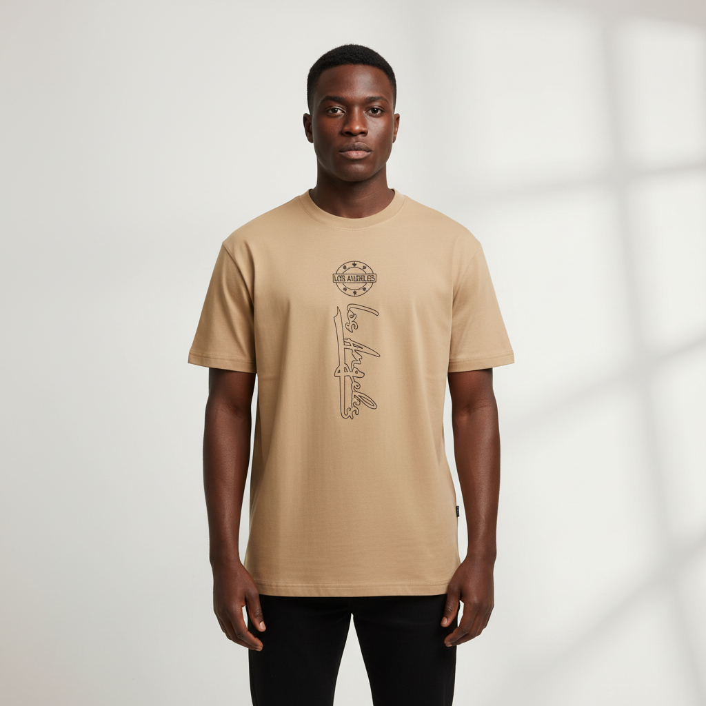 Black Nigerian male model wearing a beige Los Angeles graphic T-shirt