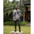 Nigerian male model wearing vintage collage graphic Cuban collar shirt — full body street style