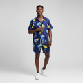African Nigerian male model wearing men's navy blue tropical palm tree print beach co-ord set
