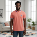Young Nigerian male model wearing salmon pink tipped polo shirt, front view