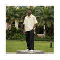 Nigerian male model full body wearing men's cream zigzag trim boxy short-sleeve shirt
