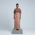 Nigerian female model wearing multicolor wave print cape and pleated blush maxi set