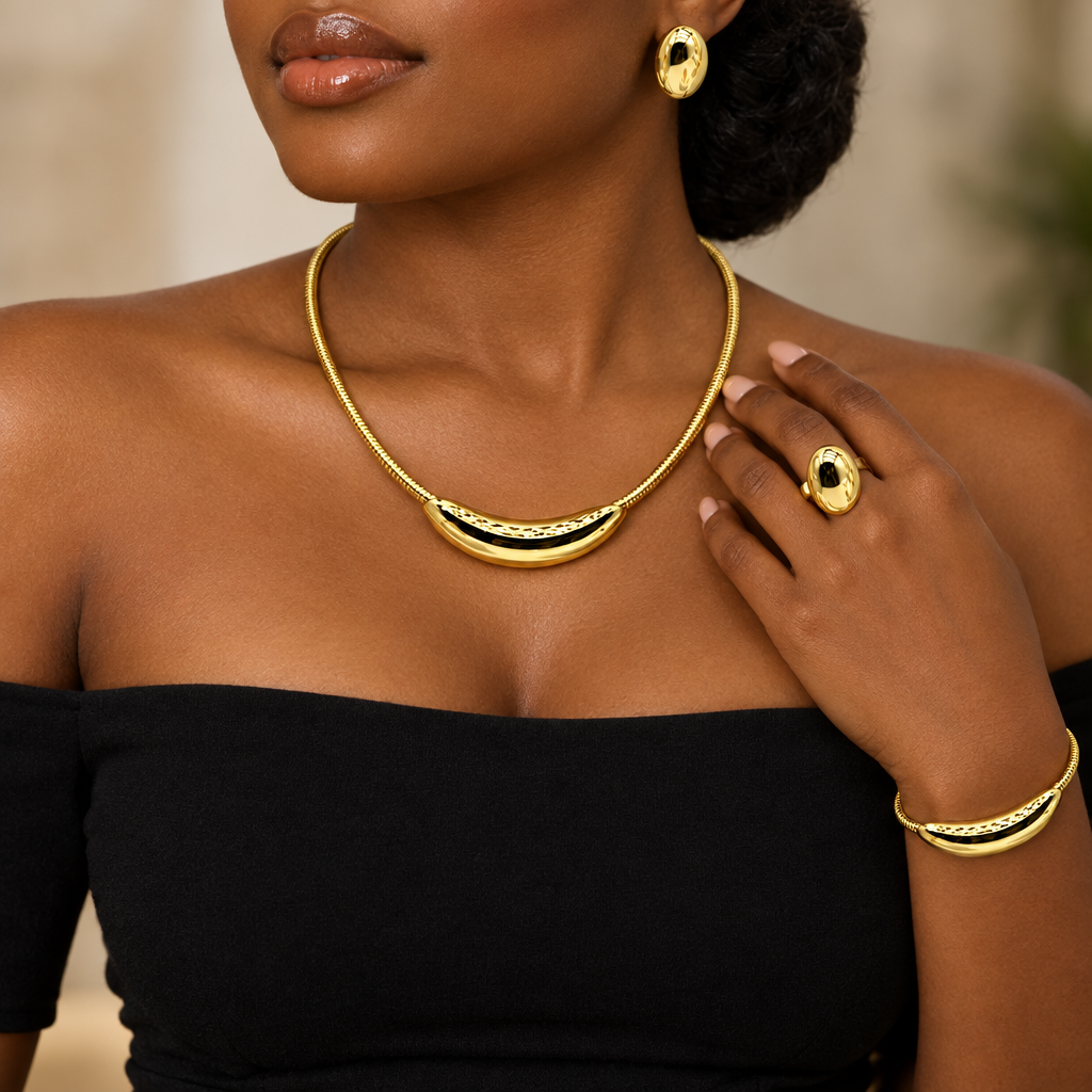 Woman wearing gold crescent necklace, stud earring, bracelet and ring set