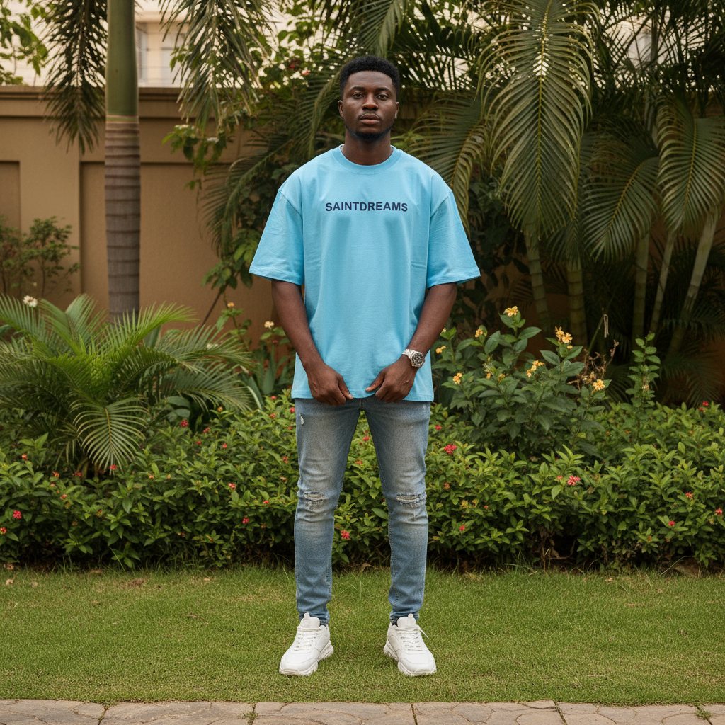 Nigerian male model wearing sky blue Saintdreams graphic tee – front view