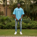 Nigerian male model wearing sky blue Saintdreams graphic tee – front view