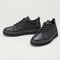 Black geometric-embossed lace-up sneakers, pair views