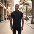 Young Nigerian male model wearing all black plain polo shirt, front view, Nigerian urban background