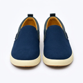 Straight-on navy dark-trim slip-on sneakers with ribbed cream soles