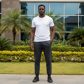 Nigerian male model wearing grey sweatpants in outdoor setting