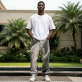 Nigerian male model wearing charcoal grey bleach splatter baggy wide-leg denim jeans
