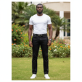 Nigerian male model wearing black trousers with accessories in outdoor setting