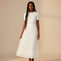 Nigerian girl wearing white bow pleated midi skirt - front view