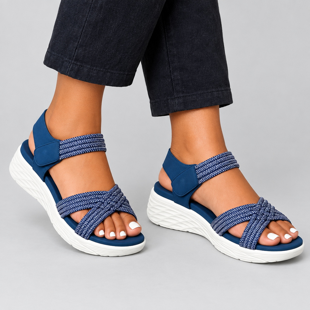 Blue cross-strap wedge sandals worn on both feet
