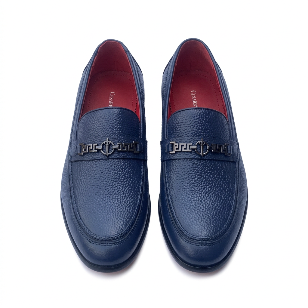 Straight-on navy textured loafers with dark geometric hardware and red lining