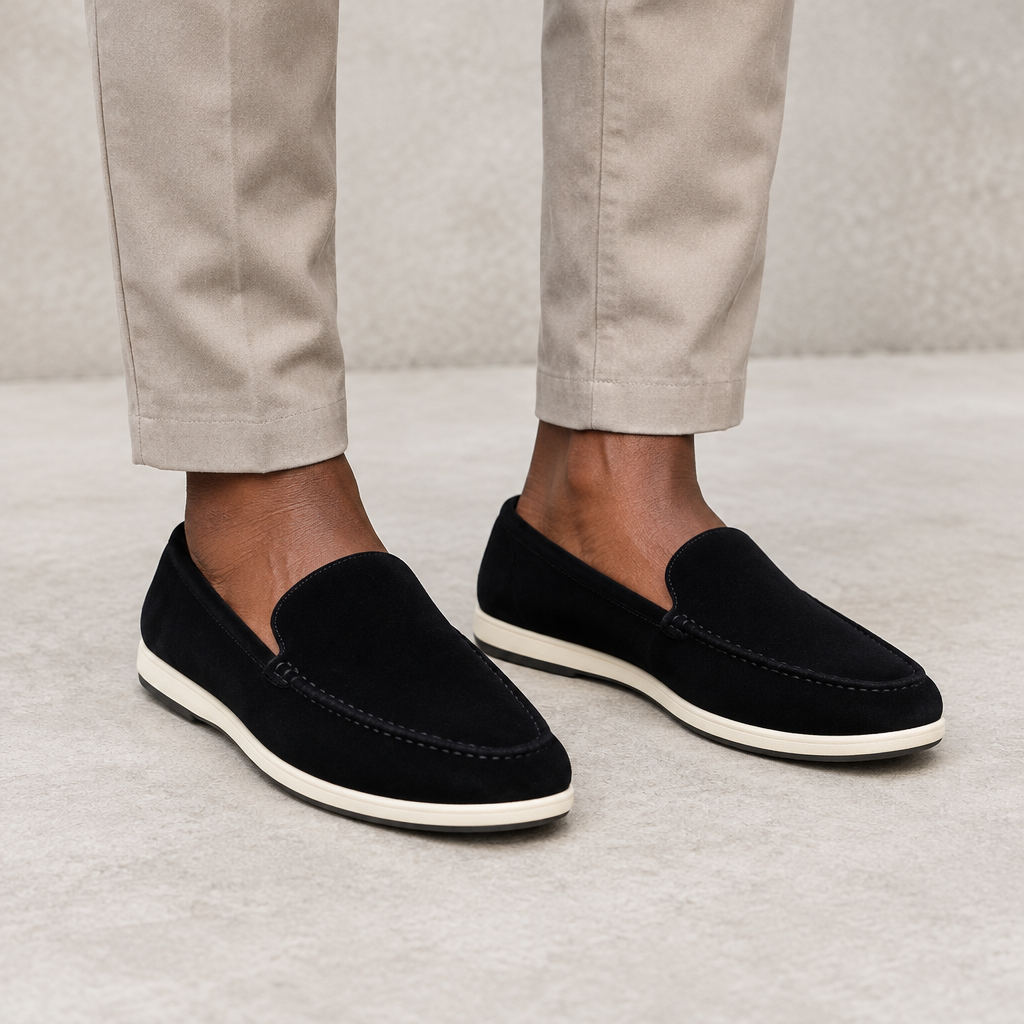 Black slip-on loafers worn on both feet