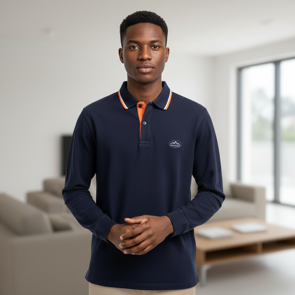Young Nigerian male model wearing navy long sleeve tipped polo shirt, front view
