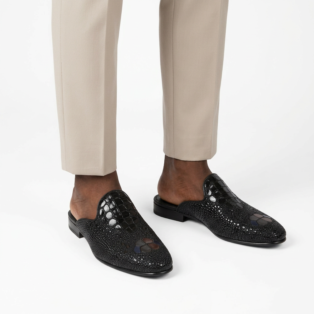 Men’s black scale-textured mule shoes worn with tailored trousers