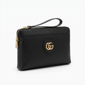 Plain textured black men's wristlet clutch with gold-tone emblem on white