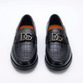 Pair of black men's croc-panel hardware loafers on white