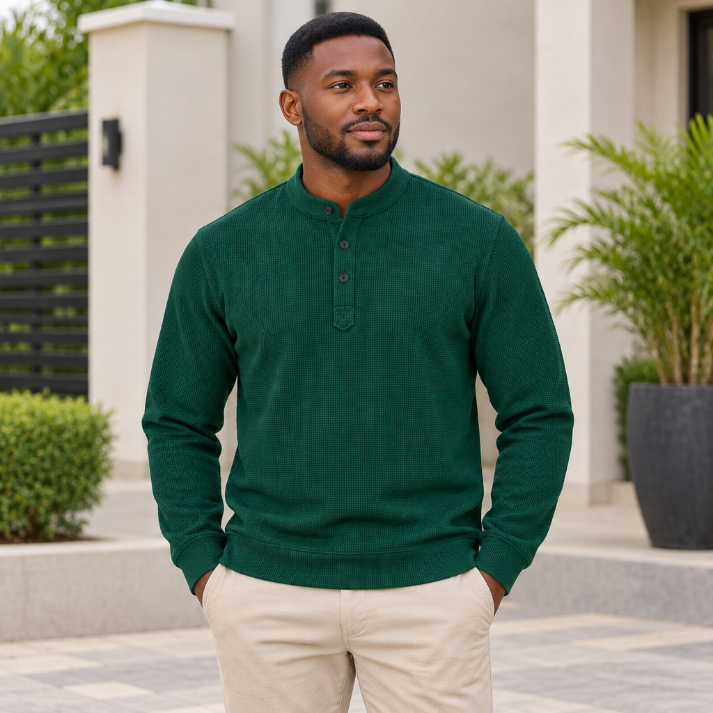 Black Nigerian adult model wearing a dark green textured long-sleeve pullover