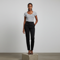 Nigerian female model wearing white and black stripe fitted top
