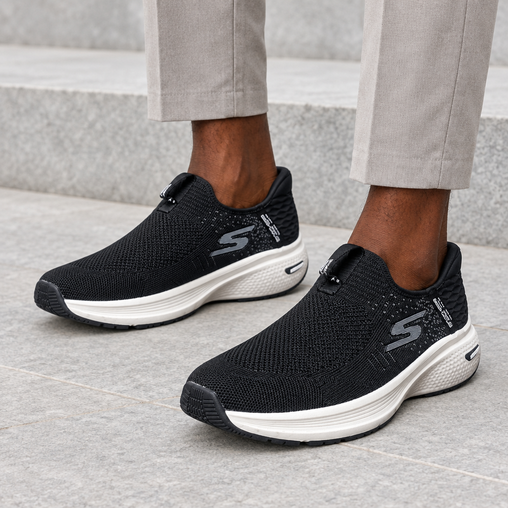 Black knit slip-on sneakers worn on both feet