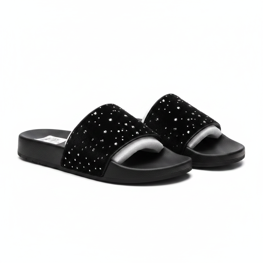 Men's black velvet slide sandals with scattered silver crystal rhinestone studs on wide strap, ghost mannequin pair view on white background