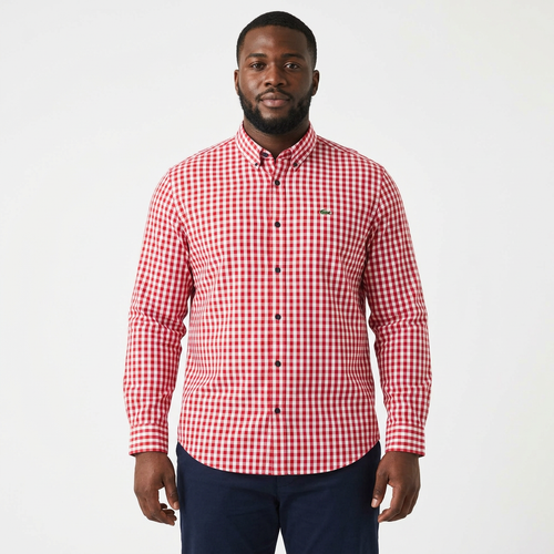 Adult Black model wearing a red and white gingham long-sleeve shirt