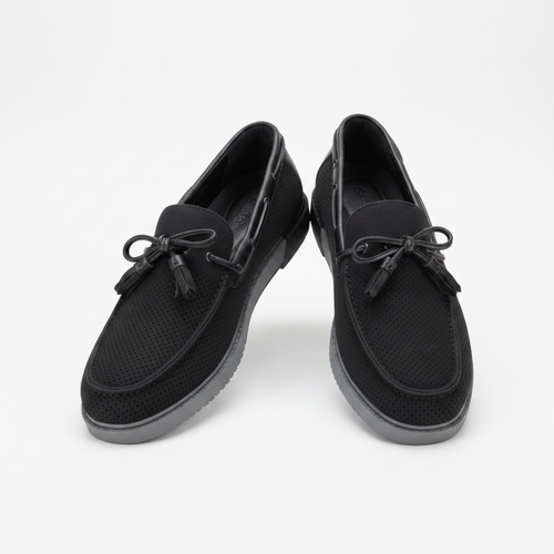Black perforated suede boat shoes with grey sole, centred on a plain off-white background