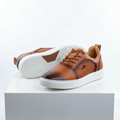 Men's tan brown leather lace-up sneakers pair on white platform