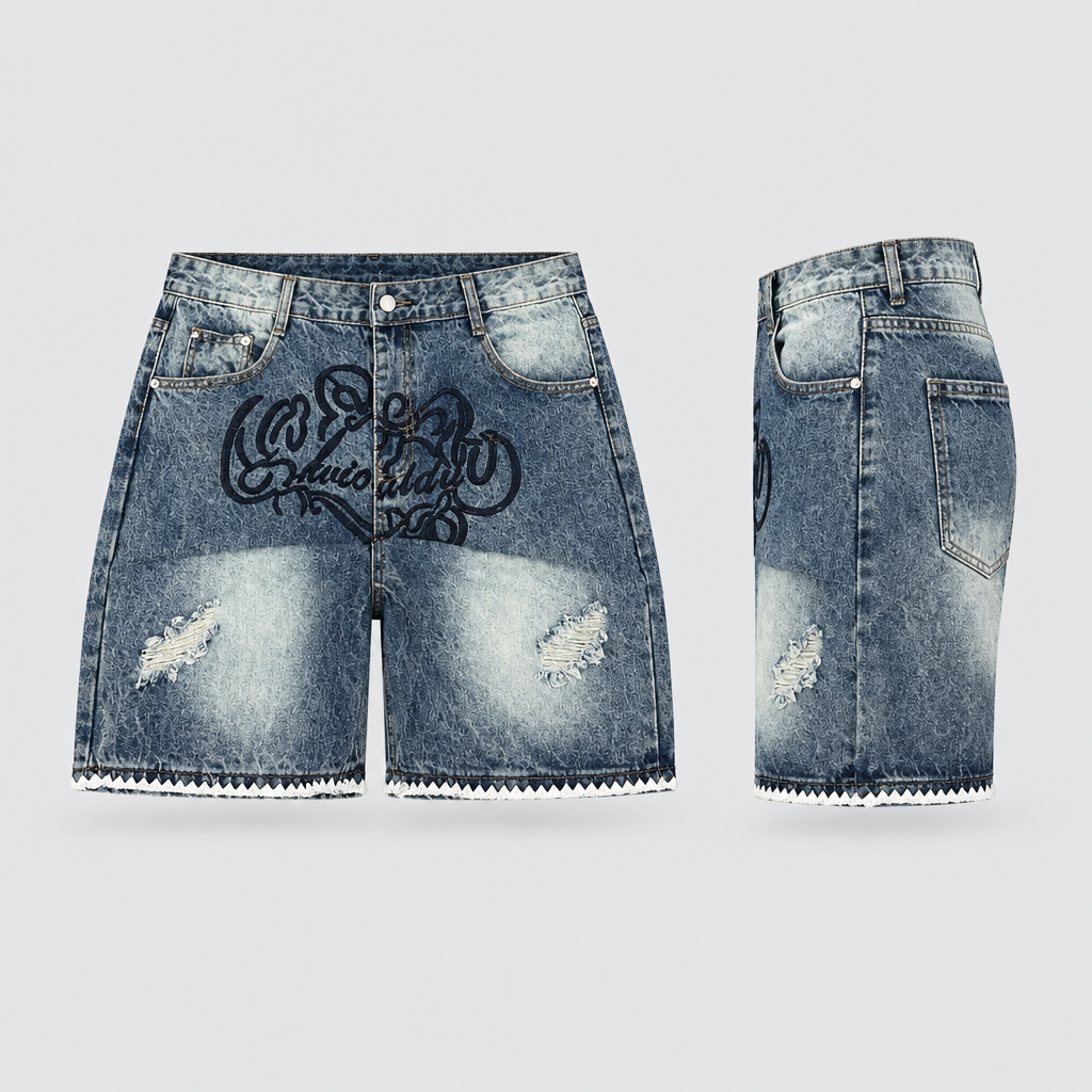 Dark-blue washed denim shorts with black script-style design and pale hem trim