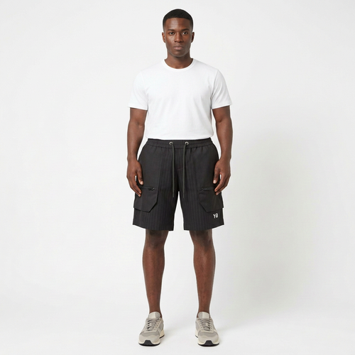 Full-body model wearing black pinstripe cargo shorts