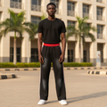 Model wearing black red white stripe track pants
