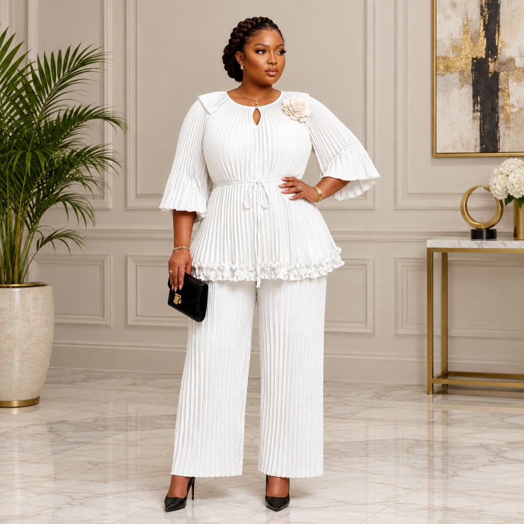 Adult Black woman wearing white pleated tunic and trousers set