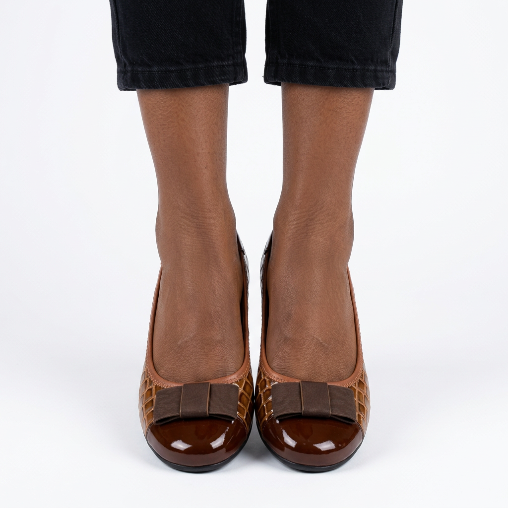 Adult woman wearing brown bow wedge shoes with feet together