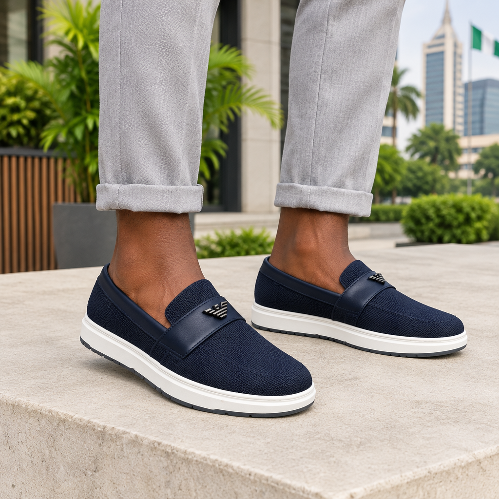 Man wearing navy knit slip-on loafer sneakers with rolled trousers