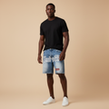Man wearing light blue embroidered denim shorts with a black t-shirt