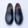 Straight-on black loafers with textured vamps and braided-detail front straps