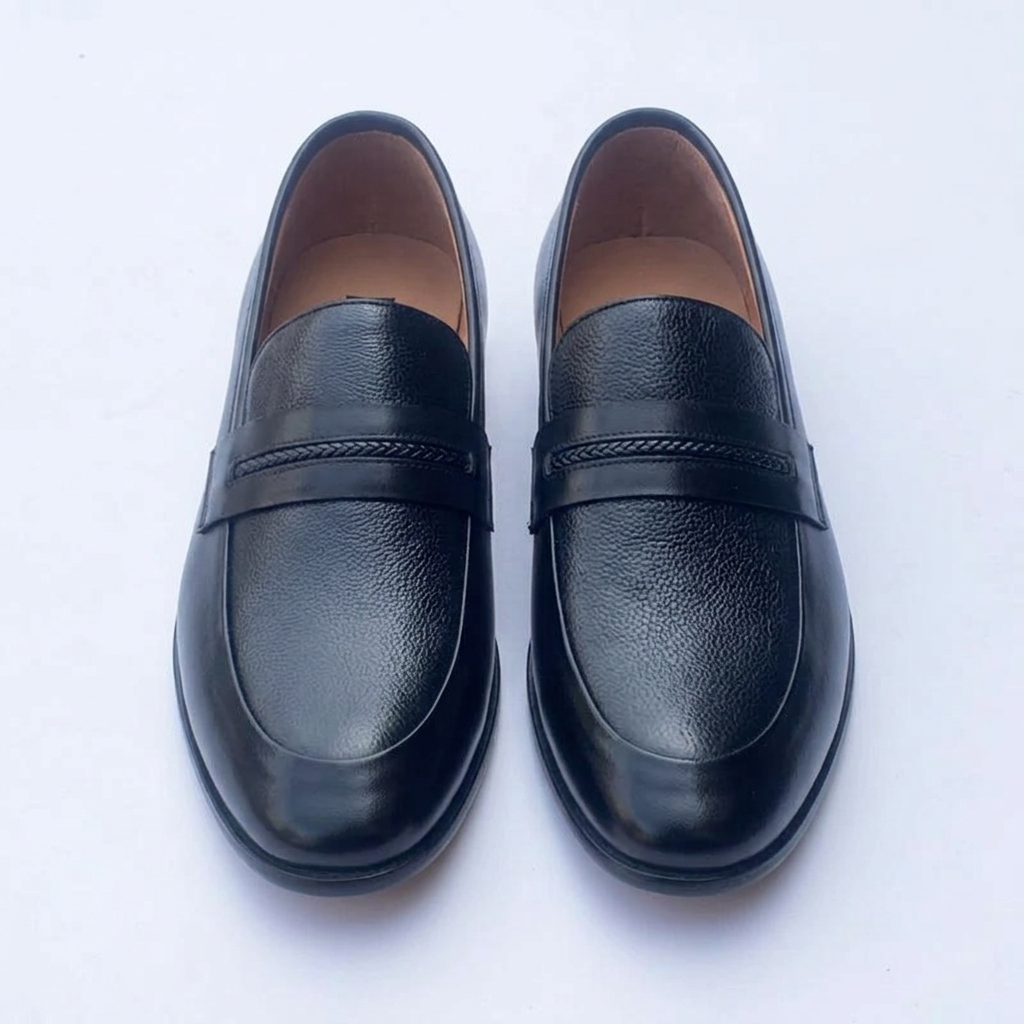 Straight-on black loafers with textured vamps and braided-detail front straps