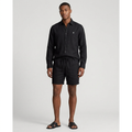 Nigerian man wearing black button-up shirt and drawstring shorts set