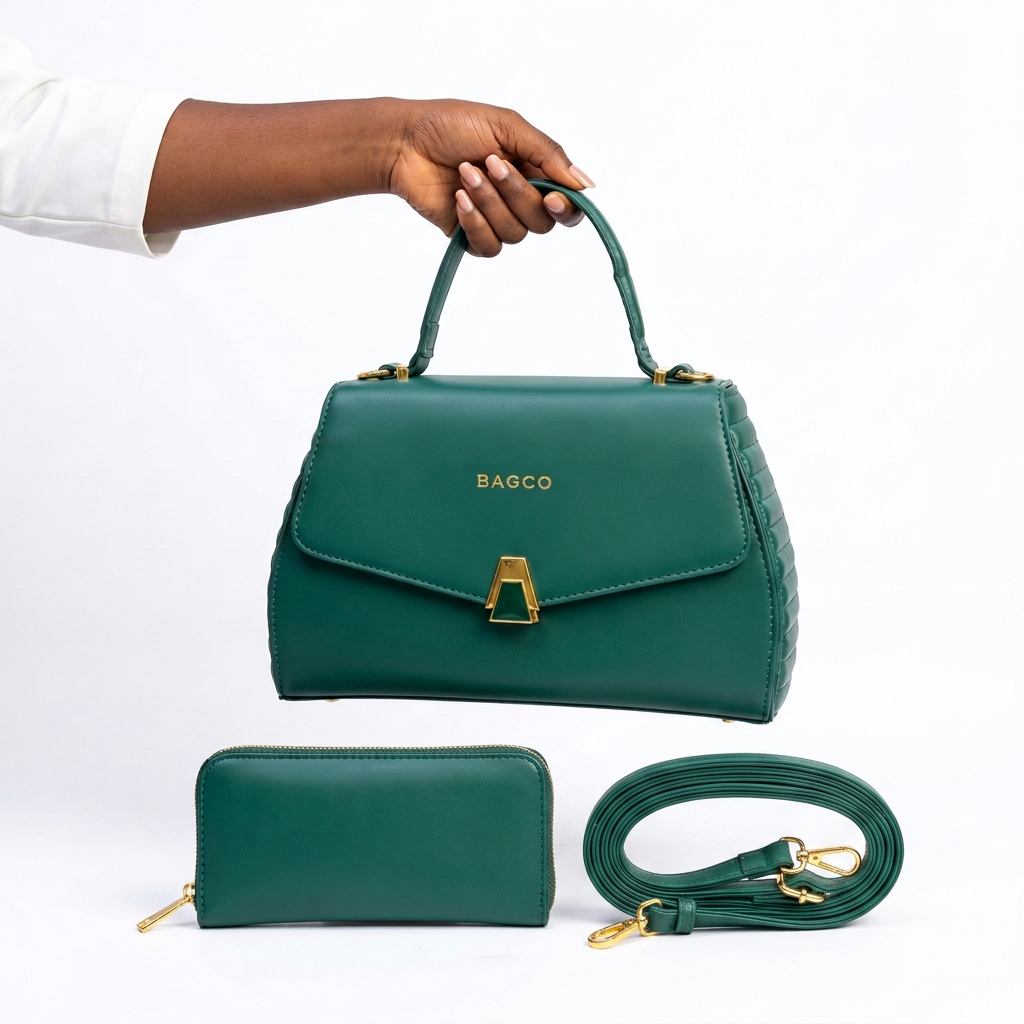 Hand holding a deep green gold-clasp handbag with matching wallet and shoulder strap
