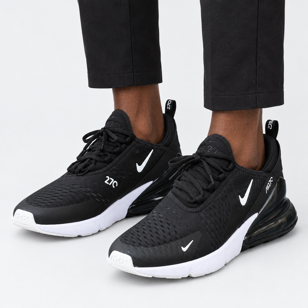 Adult wearing black-and-white mesh lace-up sneakers