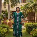 Nigerian woman wearing green bubu dress with tribal print in garden setting