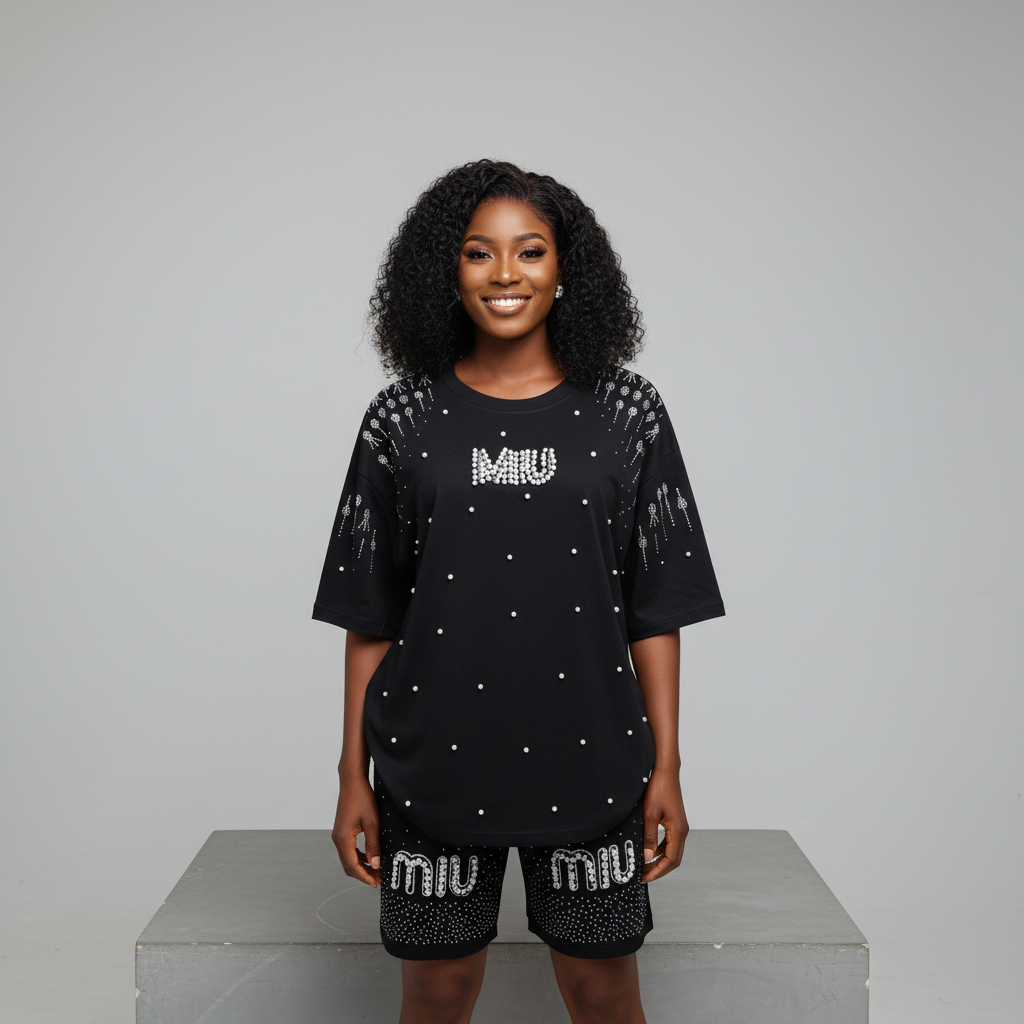 Nigerian female model front view - black pearl rhinestone top and shorts set