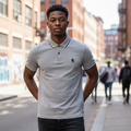 Young Nigerian male model wearing a grey marl tipped polo shirt
