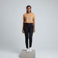 Nigerian female model front view wearing camel rhinestone circular monogram badge T-shirt