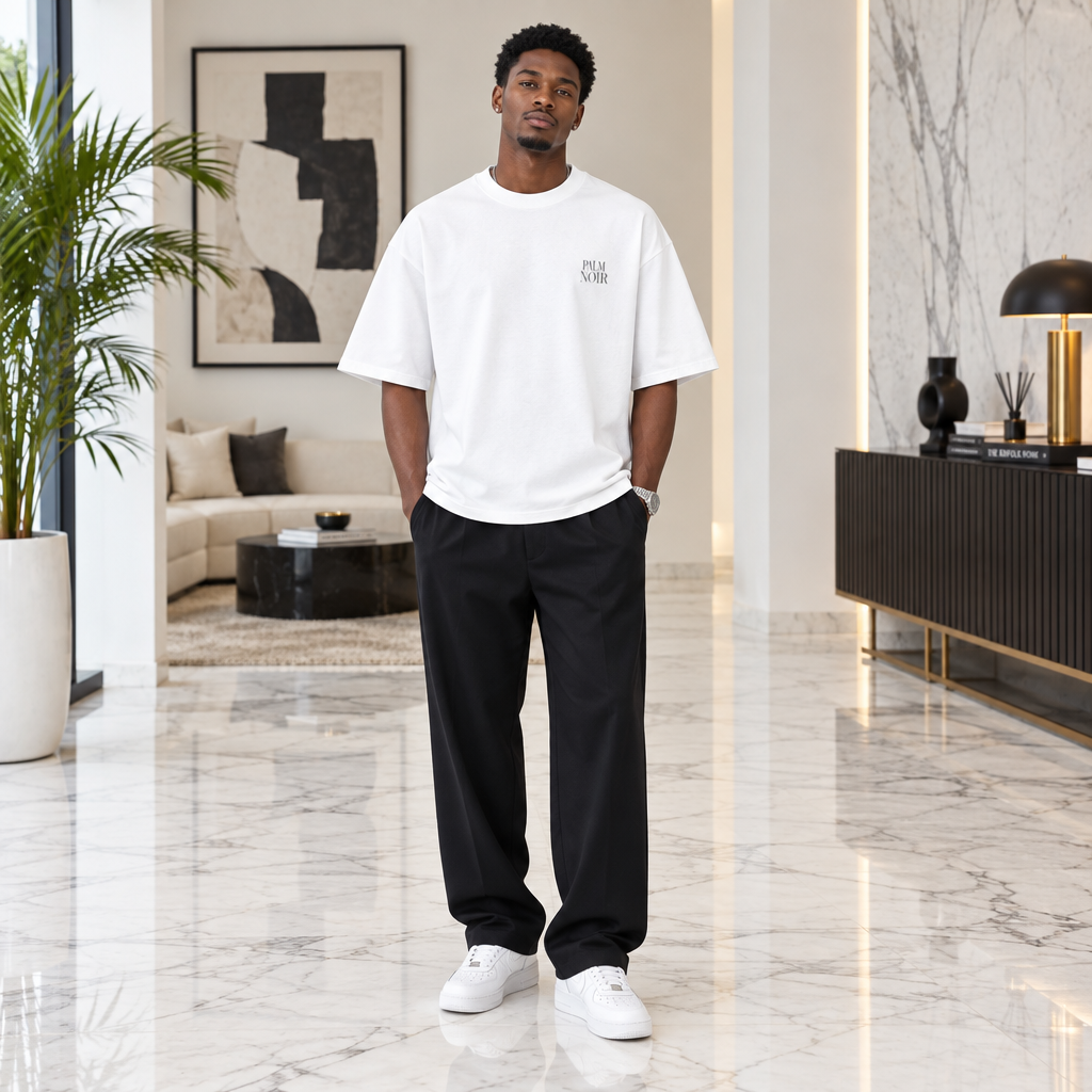Man wearing white oversized Palm Noir chest print tee