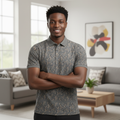 Young Nigerian male model wearing olive grey leaf print polo shirt, front view